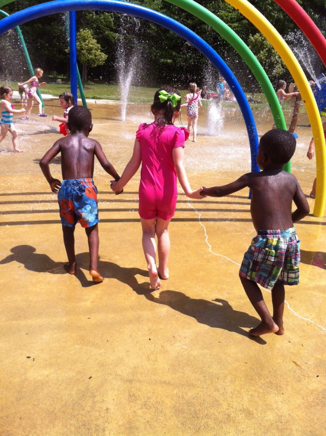 Boys playing in water with sister