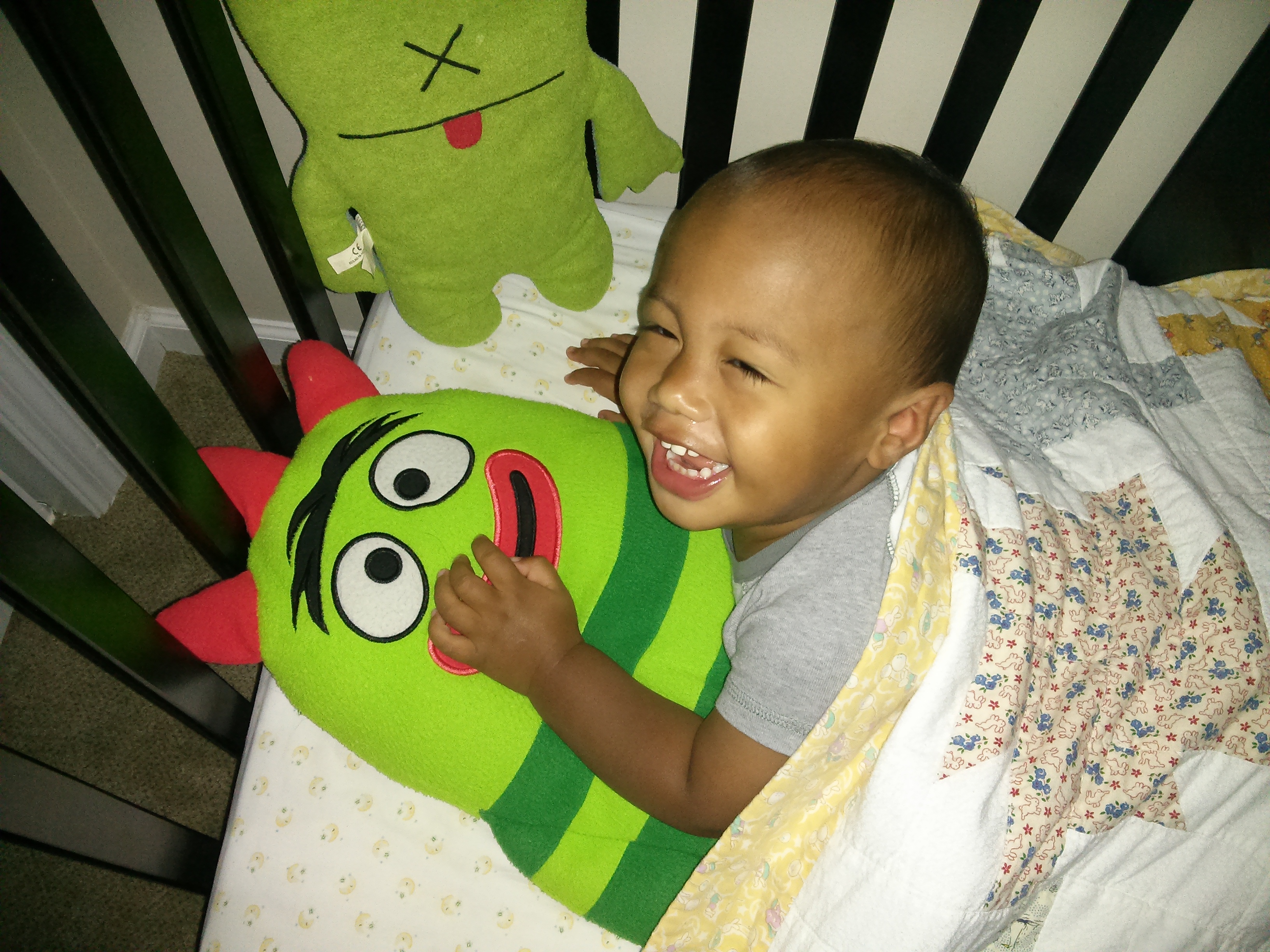 boy in crib with toy